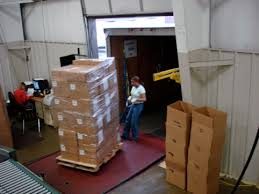 Workers unloading freight at a warehouse dock